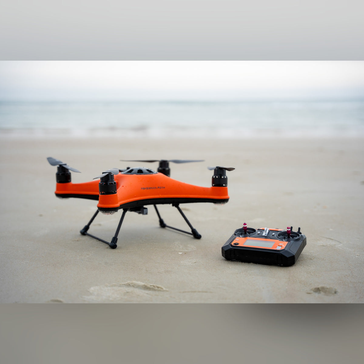 SwellPro Fisherman FD1+ and controller on the beach