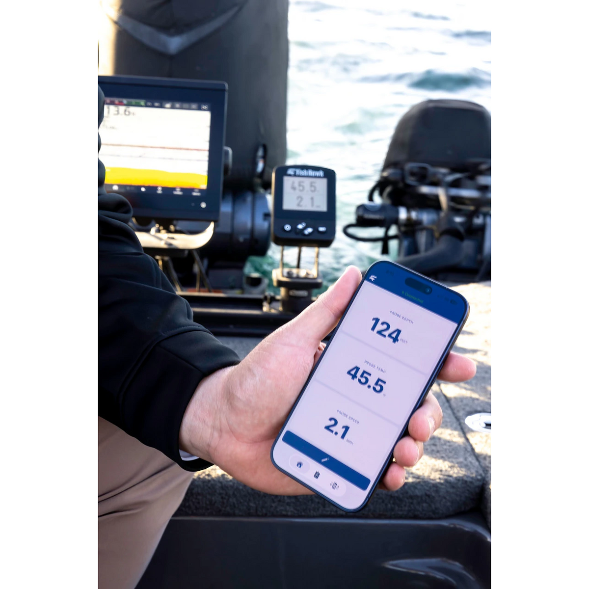 Angler viewing Fish Hawk data on the mobile app while on the water